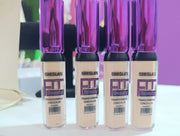 A tube of SHEGLAM FIT Beauty Transforming Concealer in a sleek design with a wand applicator.
